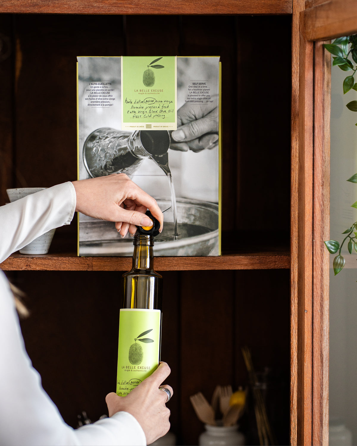 10 L container of La Belle Excuse Black Greek Extra Virgin Olive Oil, made from Mavrolia olives, with a convenient pouring spout.