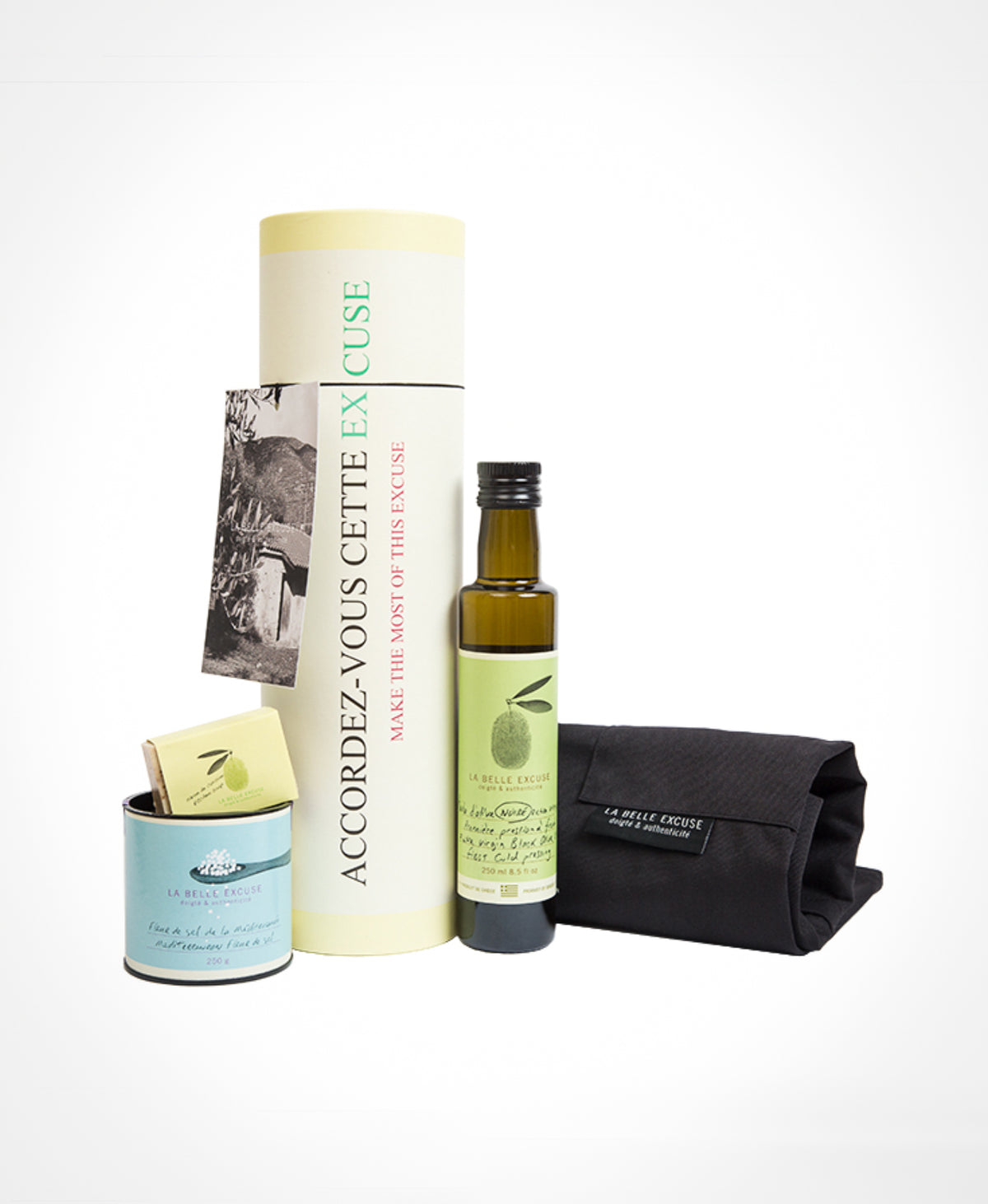 La Belle Excuse gourmet gift set featuring 250 ml black olive oil, Mediterranean fleur de sel, a unisex kitchen apron, and rosemary, lemon and coffee kitchen soap.
