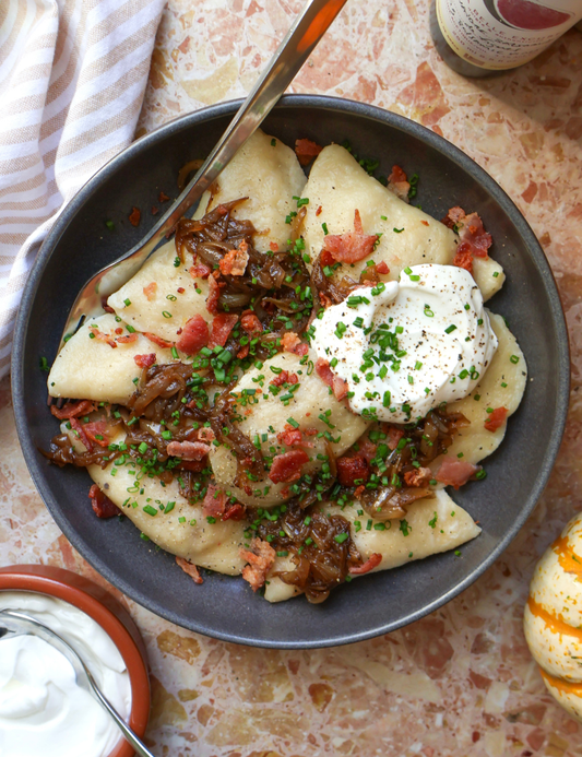 Homemade Pierogis with Squash, Caramelized Onions, Cheddar Cheese, and Bacon