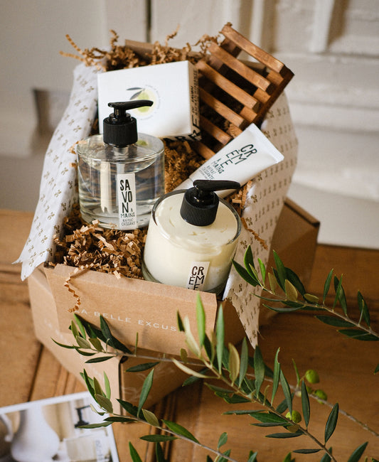 La Belle Excuse Soft Skin Gift Set featuring hand soap, hand cream, exfoliating sea salt soap, travel-size hand cream, and a wooden soap dish.