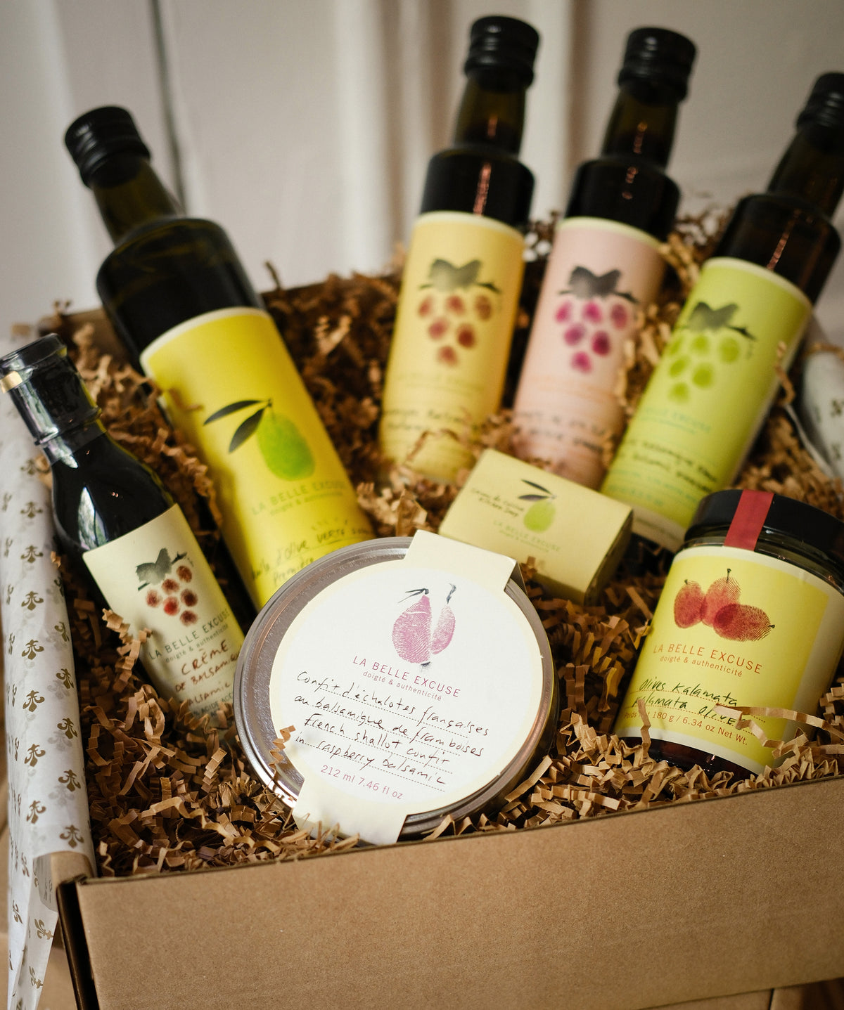 La Belle Excuse Receive in Style Gift Set featuring olive oil, three vinegars, balsamic glaze, shallot confit, kitchen soap, and Kalamata olives.
