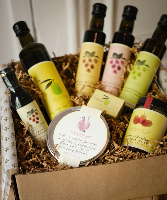 La Belle Excuse Receive in Style Gift Set featuring olive oil, three vinegars, balsamic glaze, shallot confit, kitchen soap, and Kalamata olives.

